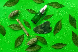 Drops of oil pipette on green leaves background. Selective focus. Nature.